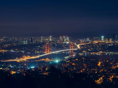 At night, the Bosphorus Bridge in Istanbul, Turkey, glows with illuminated beauty