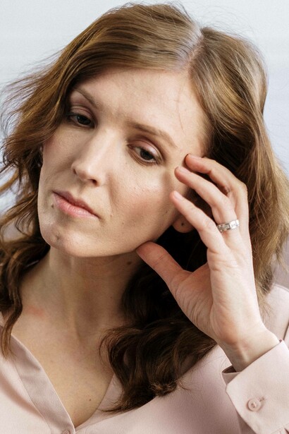 Woman in pensive mood is lost in her thoughts