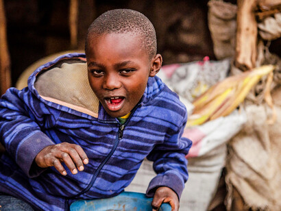 His cheerful demeanour captures the spirit of countless children living in poverty, demonstrating that laughter can be a powerful tool for overcoming hardship