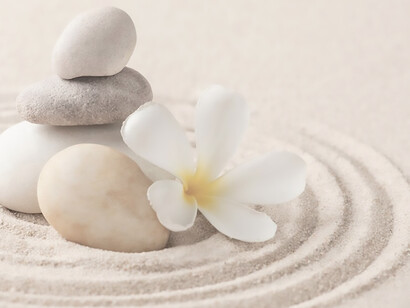 Tranquility emanates from an image featuring stacked zen marble stones against a sandy backdrop, embodying the essence of mindfulness and serenity