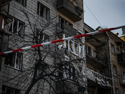 Two buildings with broken windows and a desolate aura to them