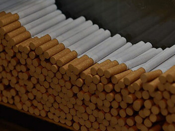 Cigarettes stacked on a wooden background