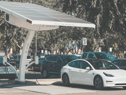 As part of the decarbonization strategy, the electric car is currently charging with electricity sourced from renewable energy, aligning with the goals of green projects to reduce carbon emissions