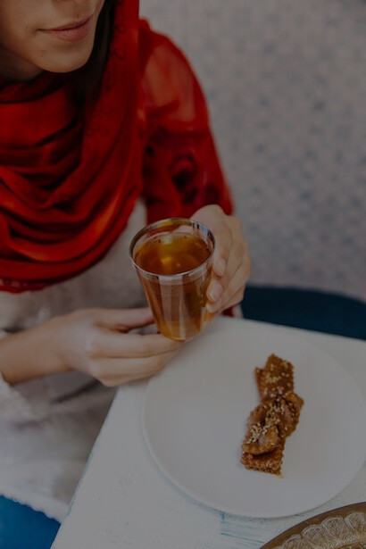 Iranian women savoring tea and baklava, reflecting Iranian culinary traditions