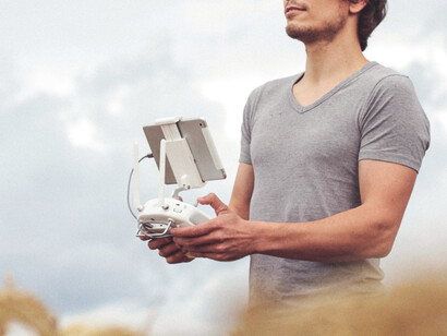 Person holding quadcopter drone