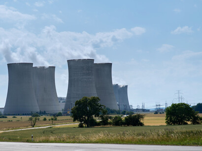 Several nuclear cooling towers releasing vapor while they generate energy