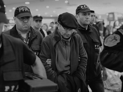 At Ministro Pistarini International Airport in Buenos Aires on December 16, 2019, former Argentinian police officer Mario Sandoval, charged with human rights violations from the "dirty war," is led by police officers following his extradition from France