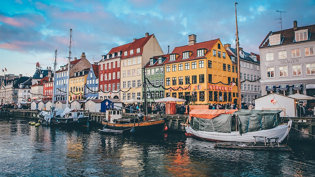 Nyhavn, located in Copenhagen, Denmark, is a picturesque waterfront area known for its vibrant atmosphere and charming architecture