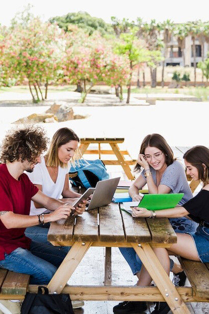 International students engaged in group study at a table, reflecting their journey in study abroad, cultural exchange, and the excitement of exploring diverse cultures
