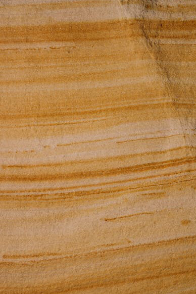 Each layer of sandstone represents a new facet of inquiry, mirroring the boundless nature of the question "Why?" and the unending journey of discovery that awaits those who dare to seek answers