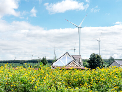 Wind turbines behind small houses in the green fields in Vietnam
