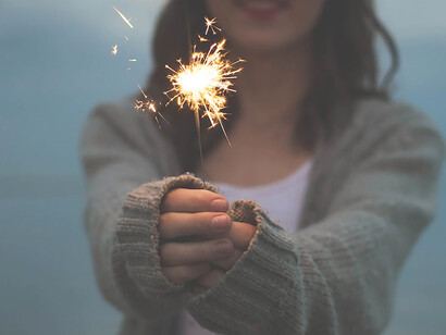 Mesmerizing moments, capturing authenticity and joy with a woman holding sparklers