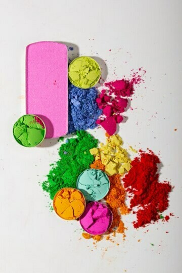 Top view of vibrant eyeshadow palettes on a white background