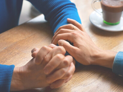 Hands holding each other in support, symbolizing generosity, reciprocity, and the mutual acts of kindness in giving and receiving