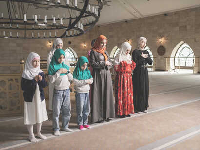 Group of women standing while praying