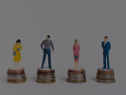 Equal wealth harmony: business man and woman seated on equal piles of coins, fostering success