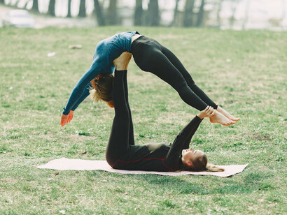 Together, two women embrace the transformative power of yoga on International Yoga Day, fostering health and harmony in their local community