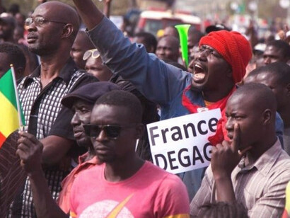 A man shouts as he holds a sign that reads, 'France get out', during a protest against French and U.N. forces, Bamako, Mali, 10 January, 2020