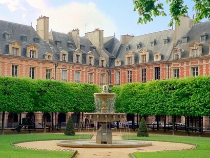 A view of the fountain in the middle of Place des Vosges in Paris, France