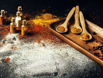 Indian spices are elegantly presented on a table, illustrating the fundamental ingredients used in the art of traditional Indian food preparation