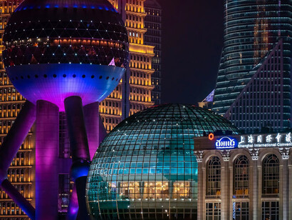 Shanghai’s skyline pulses with vibrant neon lights, casting a mesmerising purple haze over the city that never sleeps