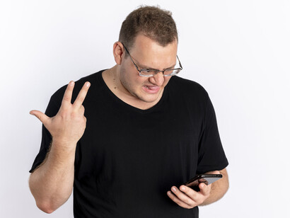 An man staring angrily at his phone