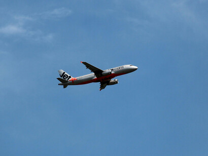 A commercial flight crossing the blue sky