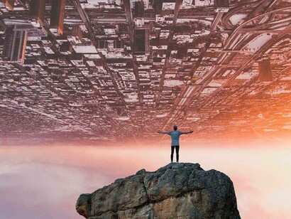 A representation of someone experiencing a drastic change in an alternate setting where the individual sees the world upside down while standing on a rock