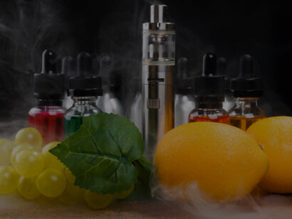 Electronic cigarette with vapor infused with lemon and a bunch of grapes, set against a black background