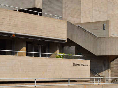 The striking concrete exterior of the National Theatre, a performing arts venue and associated theatre company located in London, England, exemplifies Brutalist architecture, showcasing bold geometric forms that captivate the eye and invite exploration
