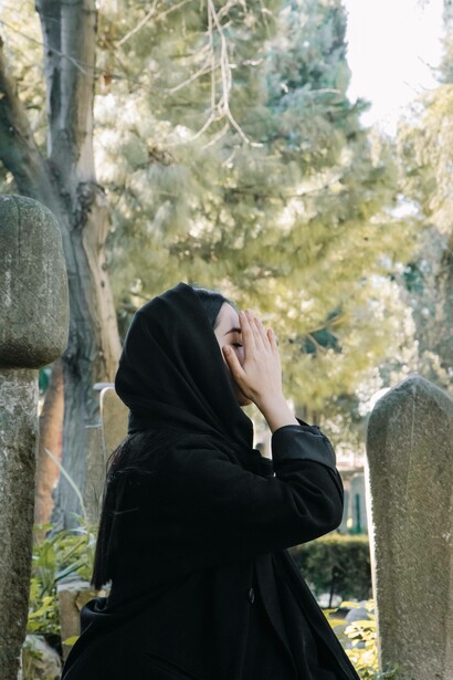 Woman praying for deceased relative