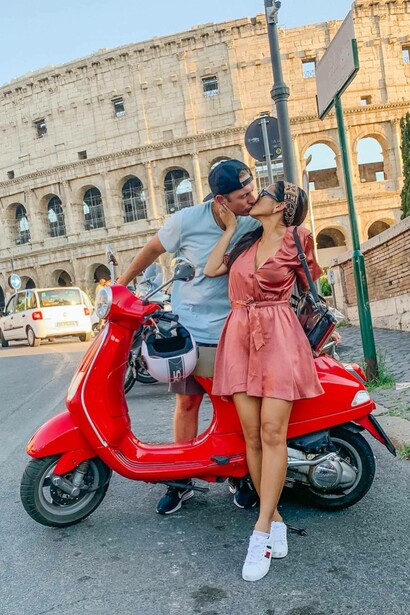 A couple kissing in front of the Roman Colosseum