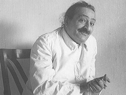 Meher Baba sitting on chair, talking, circa 1941