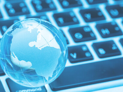 Multilingual communication with a glass world on a laptop, featuring AI translators