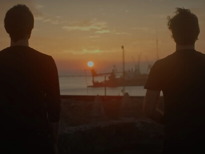 Factory pollution, smoke emissions from chimneys, and industrial air pollution from music video of Diodato: La mia terra