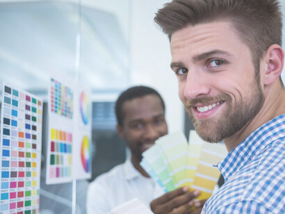 Office workers strategically employing color psychology with a palette, enhancing productivity and atmosphere through thoughtful color application