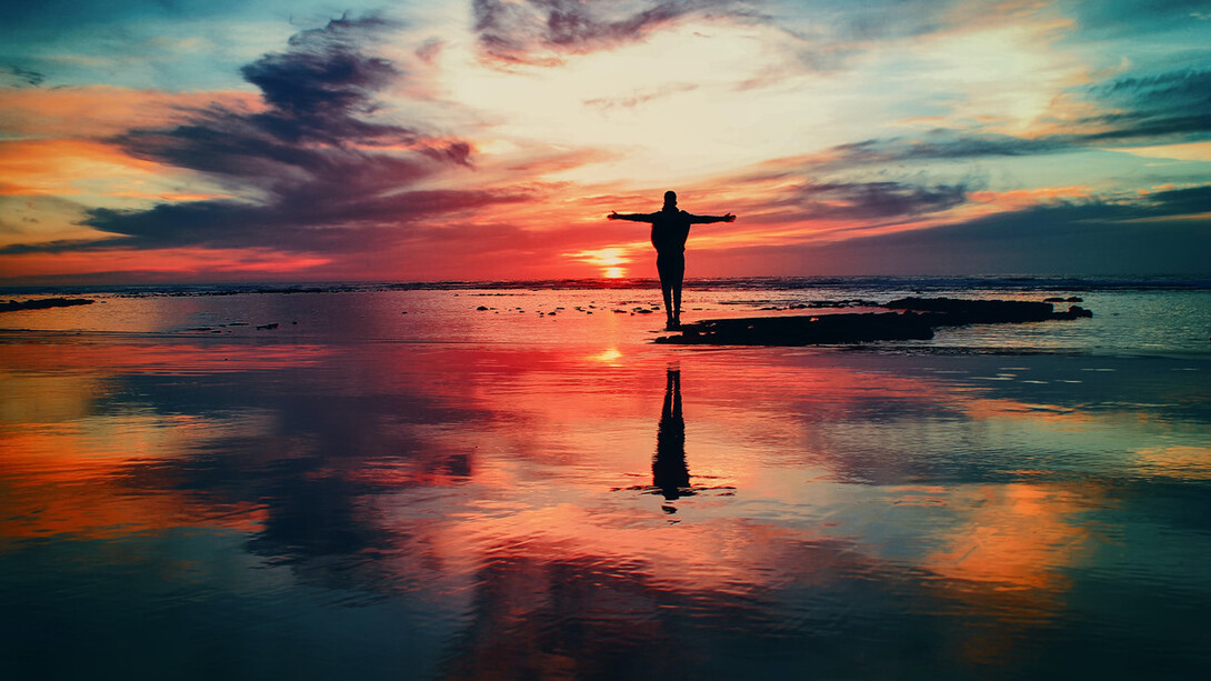 Man is standing alone at a beautiful sunset