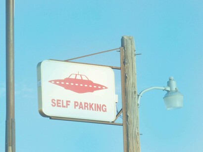 A sign welcoming UFOs in an ironic but welcoming manner