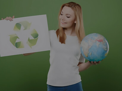 A woman holds a round globe in her hand, the other hand holds a recycling logo