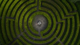 Porto, Portugal, a woman stands in the center of a labyrinth, framed by twisting paths and quiet symbolism