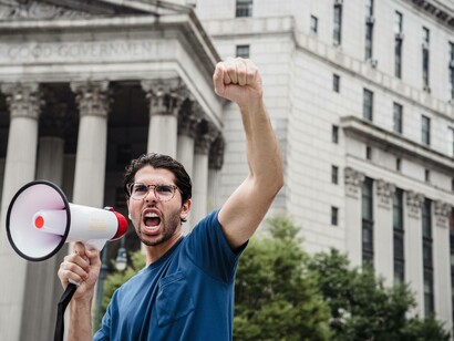 A protestor with a megaphone inciting the crowd