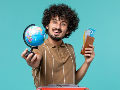Man moving abroad holding a small globe, symbolizing his journey to explore new opportunities overseas