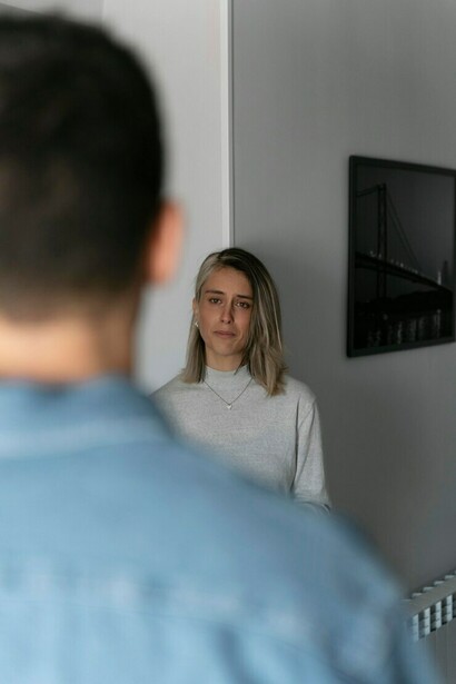 A man and woman involved in a heated argument at home, reflecting domestic violence, fear, and emotional trauma