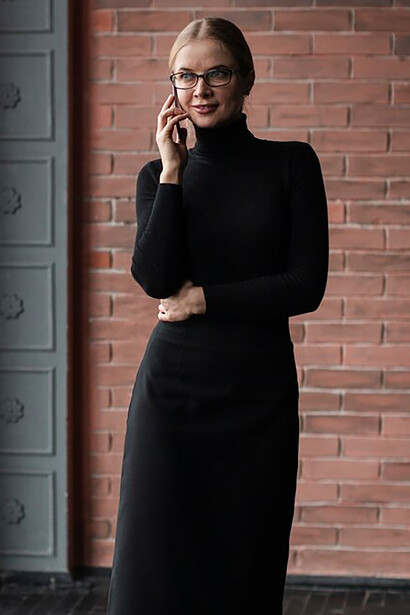 A sophisticated woman in a long black dress