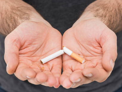 Single broken cigarette in man's hand