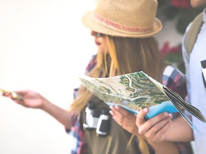 Travelers in search of direction wander through the city, pausing to study a map together, embodying the adventure of urban exploration