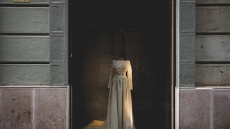 A white wedding gown on display in a haute couture boutique