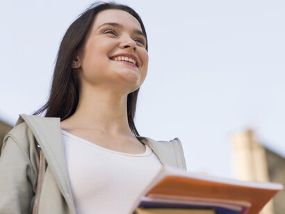A young girl smiles on her way to class
