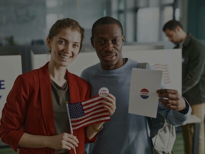 A man holding up his ballot receipt after having voted for the first time