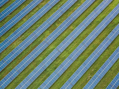 The picture showcases a set of three solar panels, poised gracefully under the sun's radiance, actively converting sunlight into a clean and eco-friendly energy source